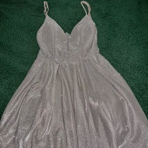 The color is rose gold. Worn once. Goes down to about the knees. Has pockets.